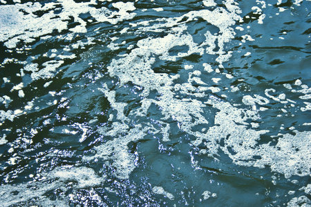 Structure of flowing water with foam and wavesの写真素材