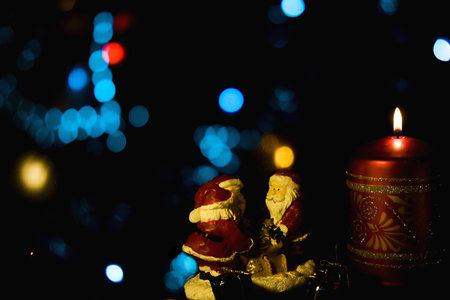 Burning candle with Christmas-tree decorationsの写真素材