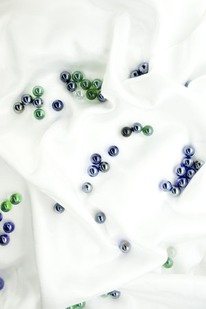 Glass balls on white silkの写真素材