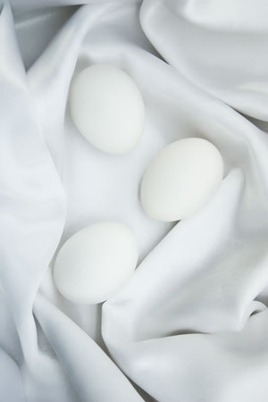 Eggs on white silkの写真素材