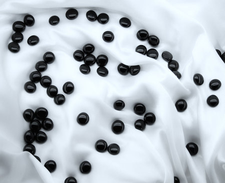 Black stones on white silk