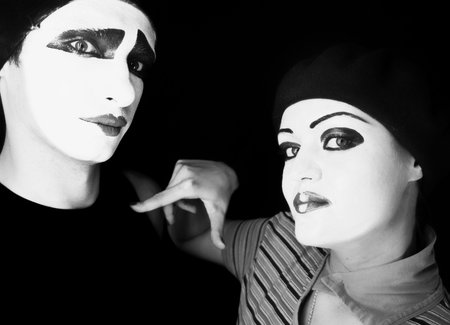 Portrait of two mimes on a black backgroundの写真素材