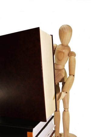 Wooden dummy with books on a white backgroundの写真素材