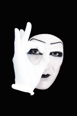 Portrait of the mime in white gloves on a black backgroundの写真素材