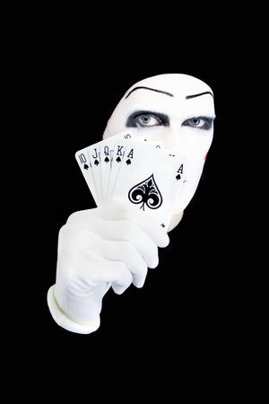 Portrait of the mime with playing cards on a black backgroundのeditorial素材