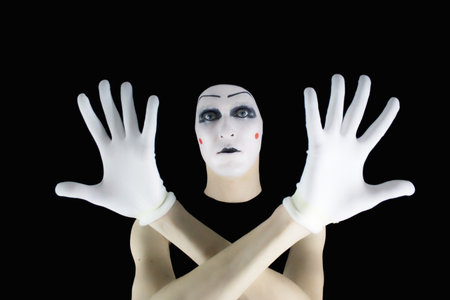 Portrait of the mime in white gloves on a black backgroundの写真素材