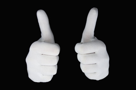 Hands in white gloves isolated on a black background