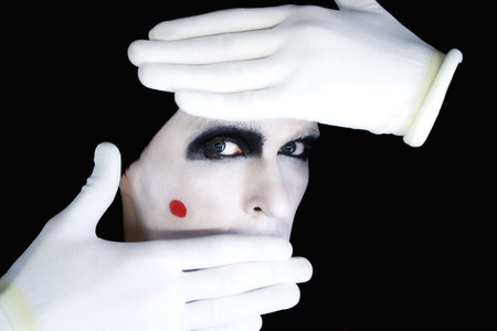 Portrait of artful peeping mime in white glovesの写真素材