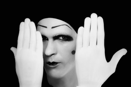 Portrait of artful peeping mime in white glovesの写真素材