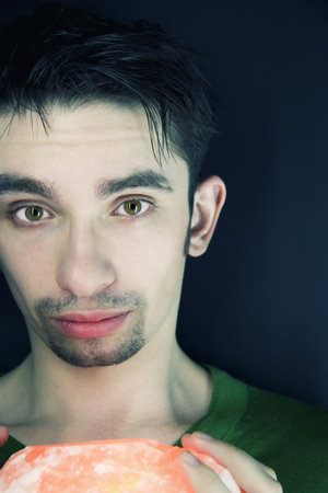 Portrait of the young guy on a black background
