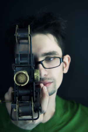 Portrait of the young guy with a videocamera