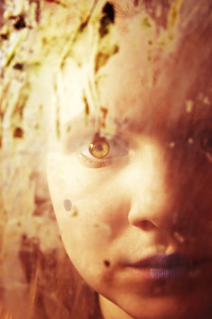 Portrait of the girl behind dirty glassの写真素材