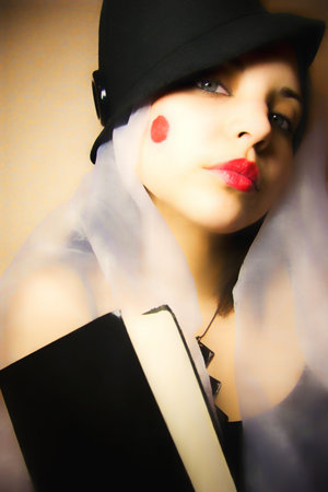 woman in a hat and a kerchief whis a book