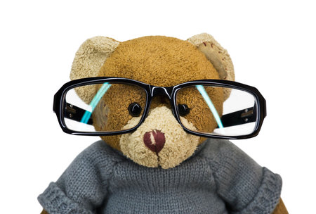 Teddy bear in glasses on a white backgroundの写真素材