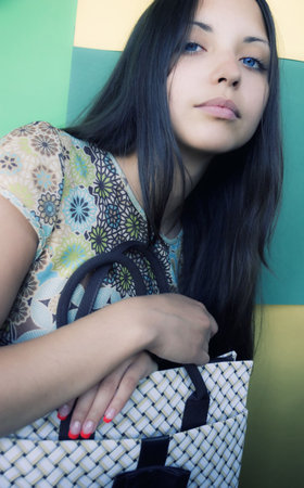 young beautiful stylish brunette woman with  bagの写真素材