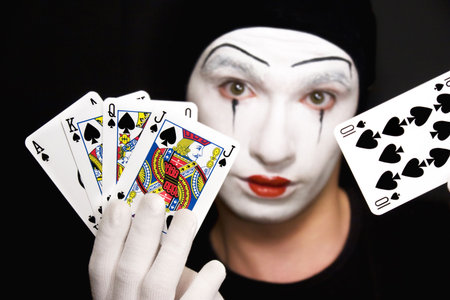 Portrait of  mime with playing cards on  black backgroundのeditorial素材