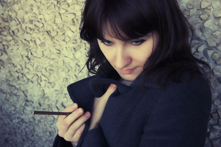 Portrait of young woman with  cigaretteの写真素材
