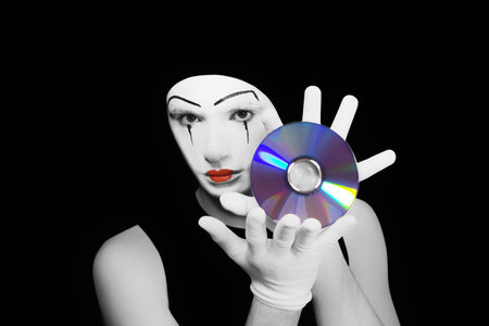 Portrait of  mime with cd on  black backgroundの写真素材