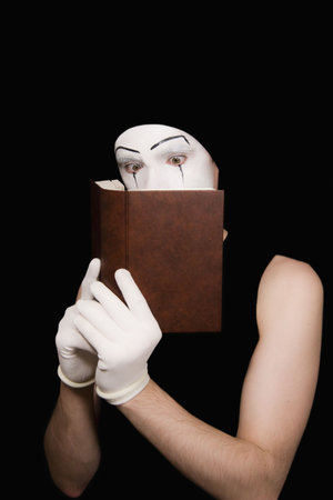 Portrait of  mime in white gloves with the bookの写真素材