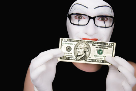 Portrait of  mime in white gloves  with 10 dollar denomination