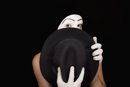 Surprise mime with a hat on a black backgroundの写真素材