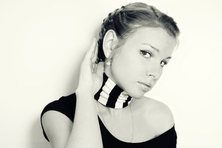 young girl in a scarf on light backgroundの写真素材