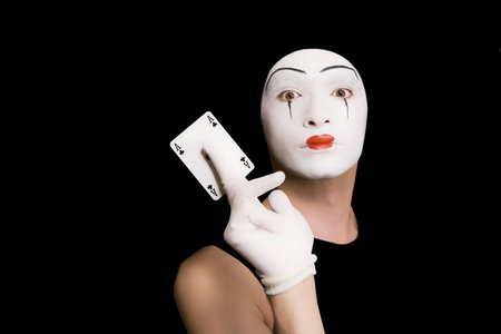 Portrait of  mime with playing cards on  black backgroundの写真素材