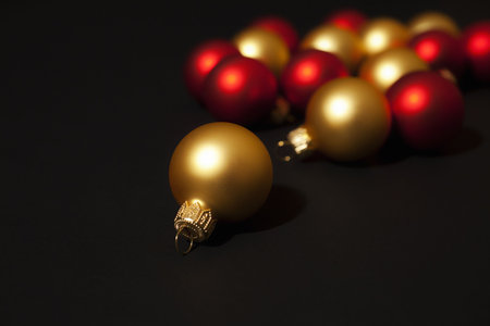 Gold and red christmas ornaments on  black backgroundの写真素材