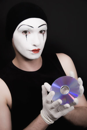 Portrait of the mime with cd on black backgroundの写真素材