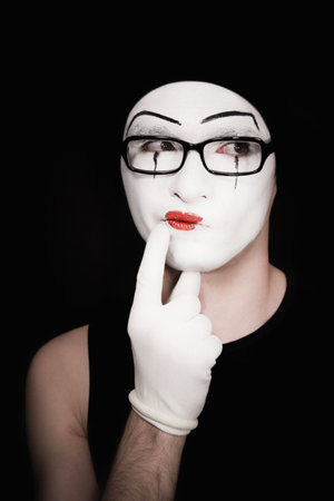 thoughtful portret of the mime on a black backgroundの写真素材