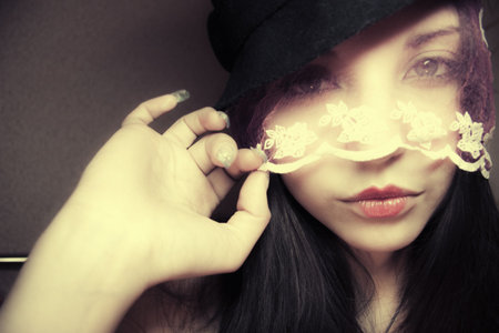 Portrait of the beautiful woman in a hat and a veil