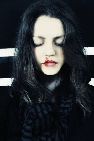 portert of young beautiful dead girl with blood on his lip