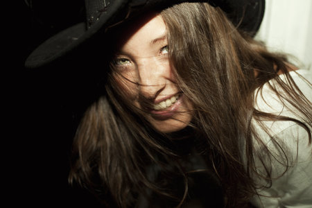 Portrait of young beautiful brunette woman wearing cowboy hat closeup