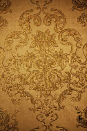 Beautiful floral pattern on  golden fabric closeupの写真素材
