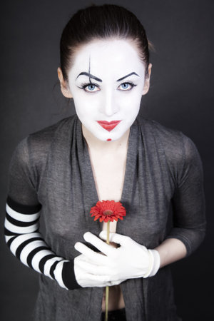 woman  mime with  red flowerの写真素材