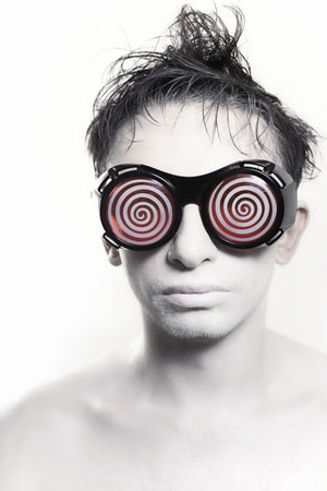 Portrait of a young man with white skin in strange glasses
