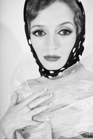 Young beautiful woman wearing headscarf and white scarfの写真素材