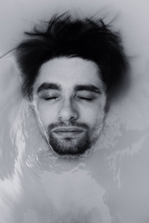 face of the young men in the muddy water closeの写真素材