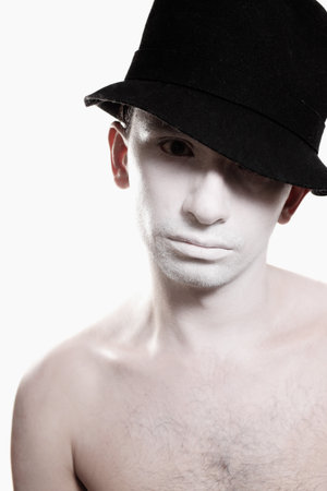 Face handsome young guy with white makeup and black hat isolated の写真素材
