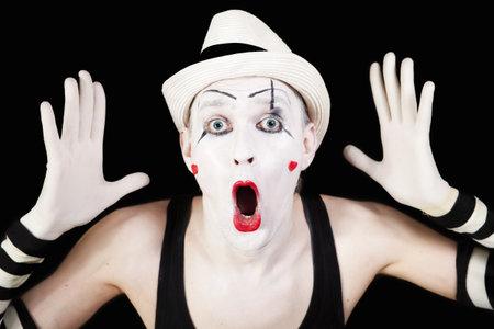 mime in striped gloves and white hat on black backgroundの写真素材