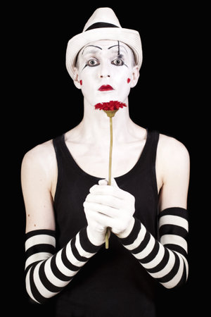 mime in white hat with red gerberasの写真素材