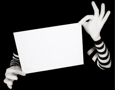 hands in striped gloves hold a white blankの写真素材