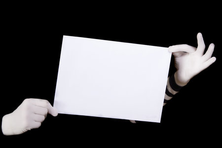 hands in striped gloves hold a white blank on black backgroundの写真素材