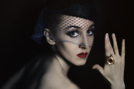 Retro portrait of beautiful young woman in  veil with  ring