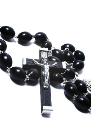 Catholic black wooden beads with metal crucifix isolated on white backgroundの写真素材