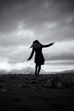 young woman on the sandy beaches of the storm