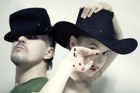 Double studio portrait of a man and a woman with a theatrical makeup closeupの写真素材