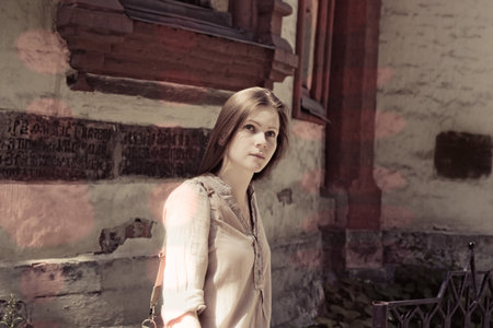 Portrait of a young beautiful woman on the street of the old cityの写真素材