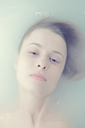 Face beautiful young woman in troubled watersの写真素材