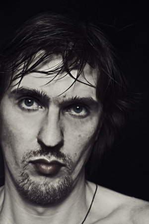 portrait of a young serious man with blue eyes and a stylish hairstyle
